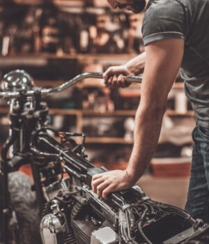 Man,Examining,Motorcycle.,Close-up,Of,Young,Man,Examining,Motorcycle,In